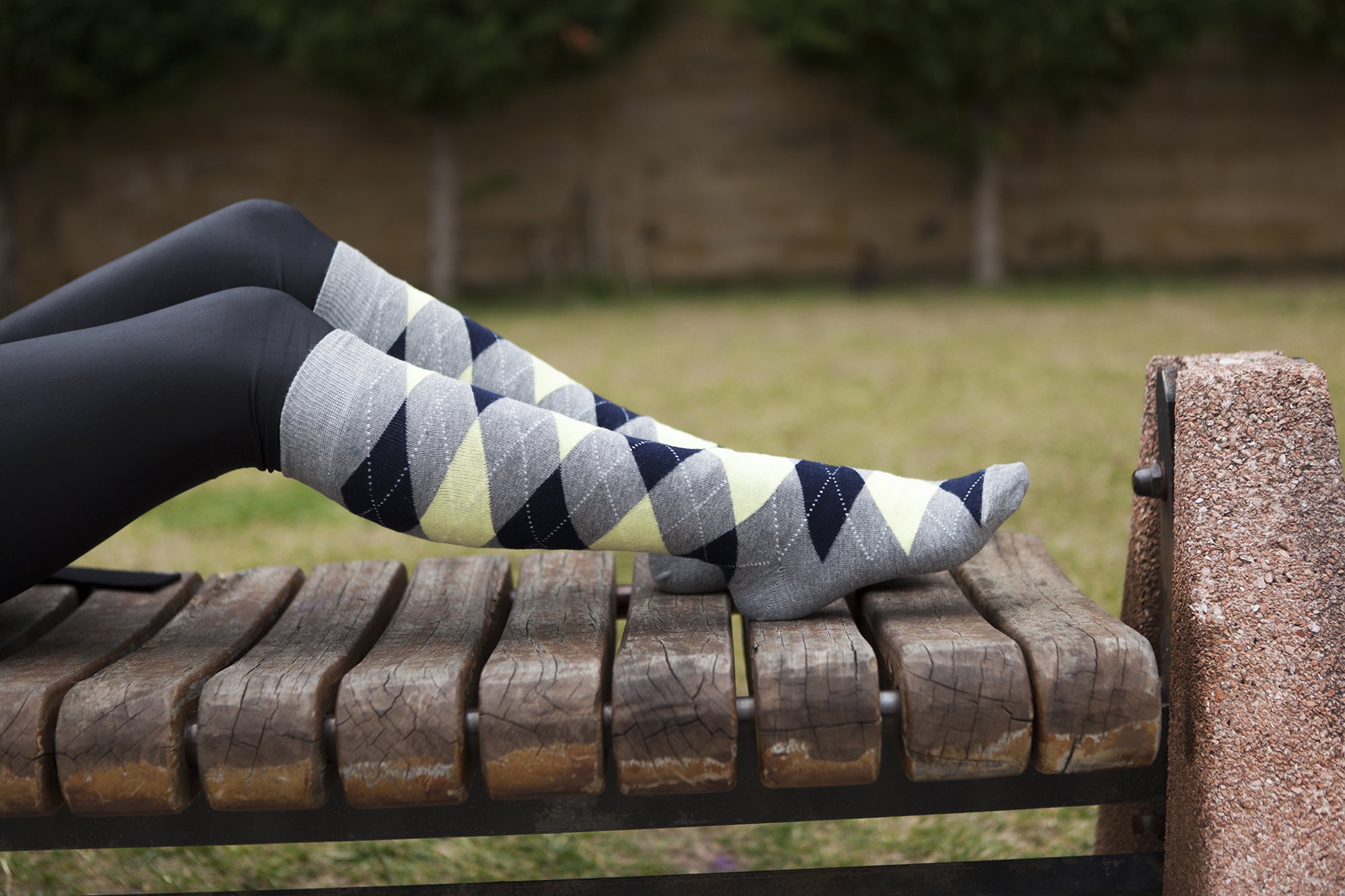 A pair of Women's Cloud Argyle Knee High Socks featuring vibrant colors and trendy patterns, perfect for adding style to any outfit.