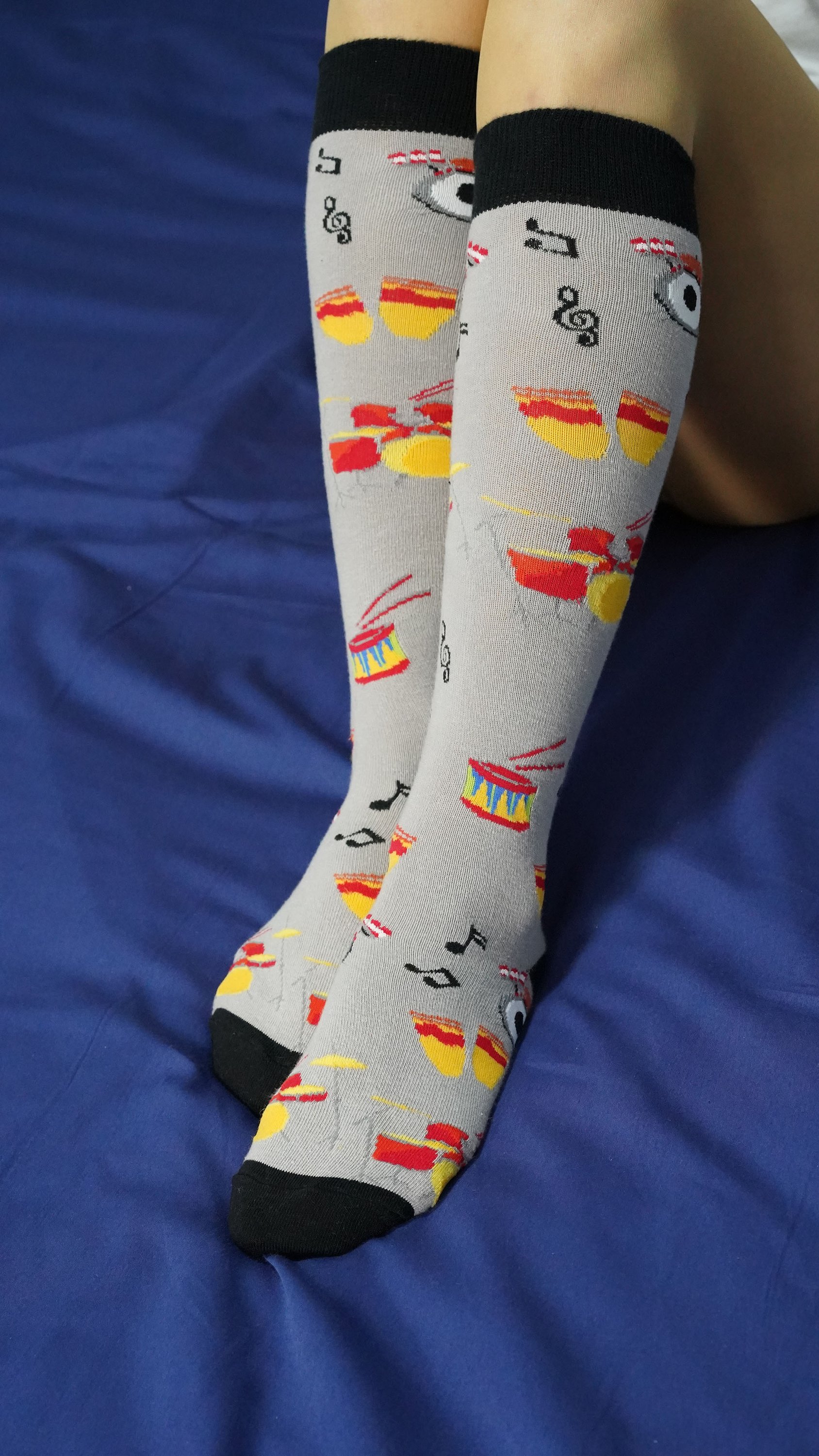 A pair of colorful Women's Drums Knee High Socks featuring trendy patterns and a comfortable fit, perfect for stylish outfits.