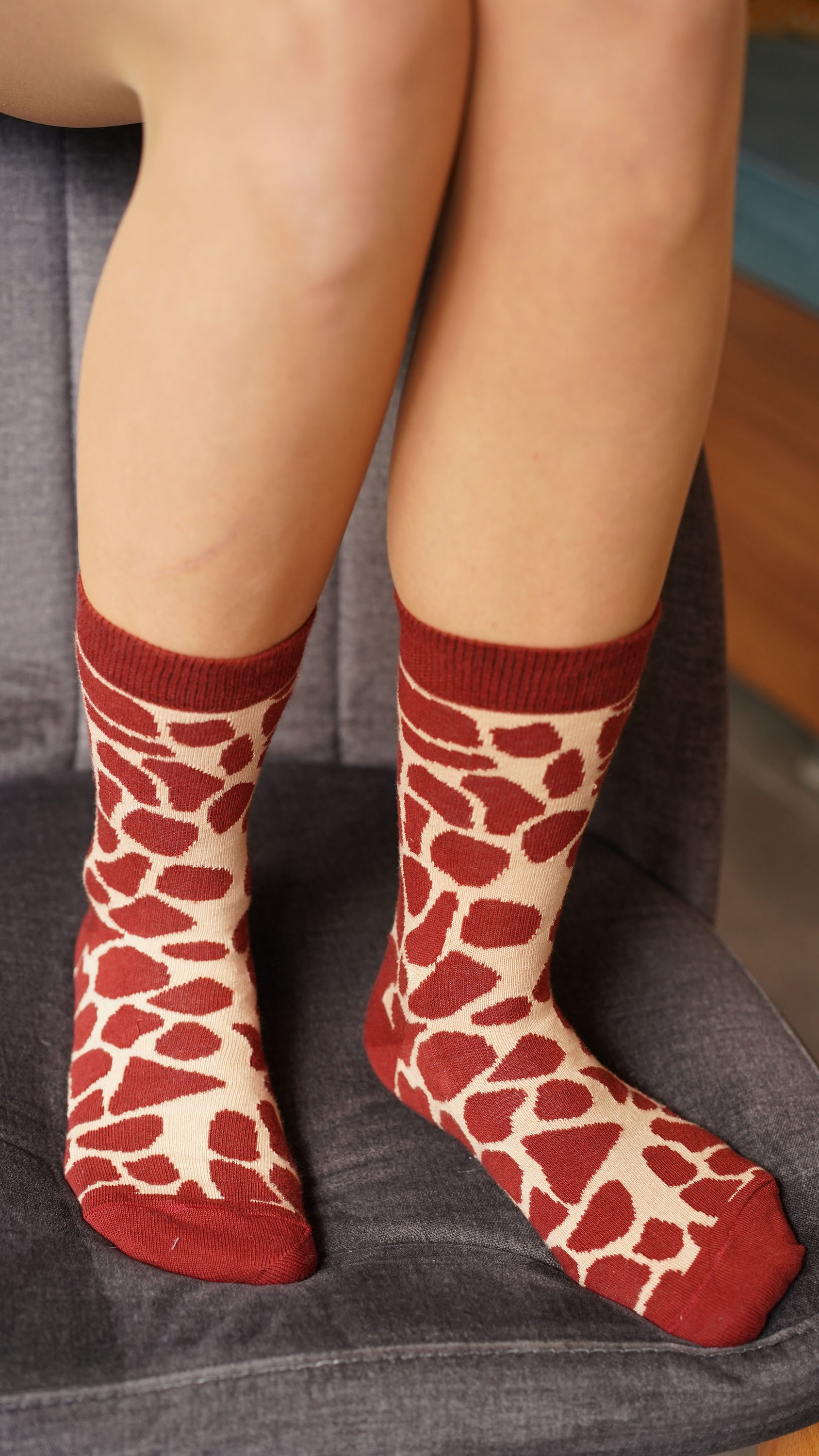 Colorful women's socks featuring a playful giraffe design, made from soft cotton for comfort.