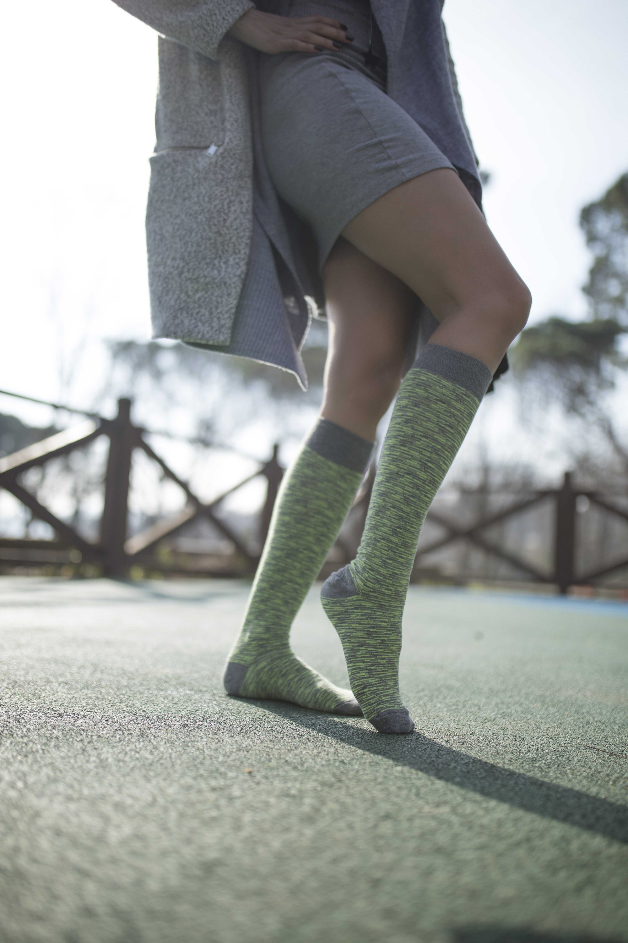 A pair of vibrant Women's Lime Grizzled Stripe Knee High Socks showcasing a colorful striped pattern, perfect for adding flair to any outfit.