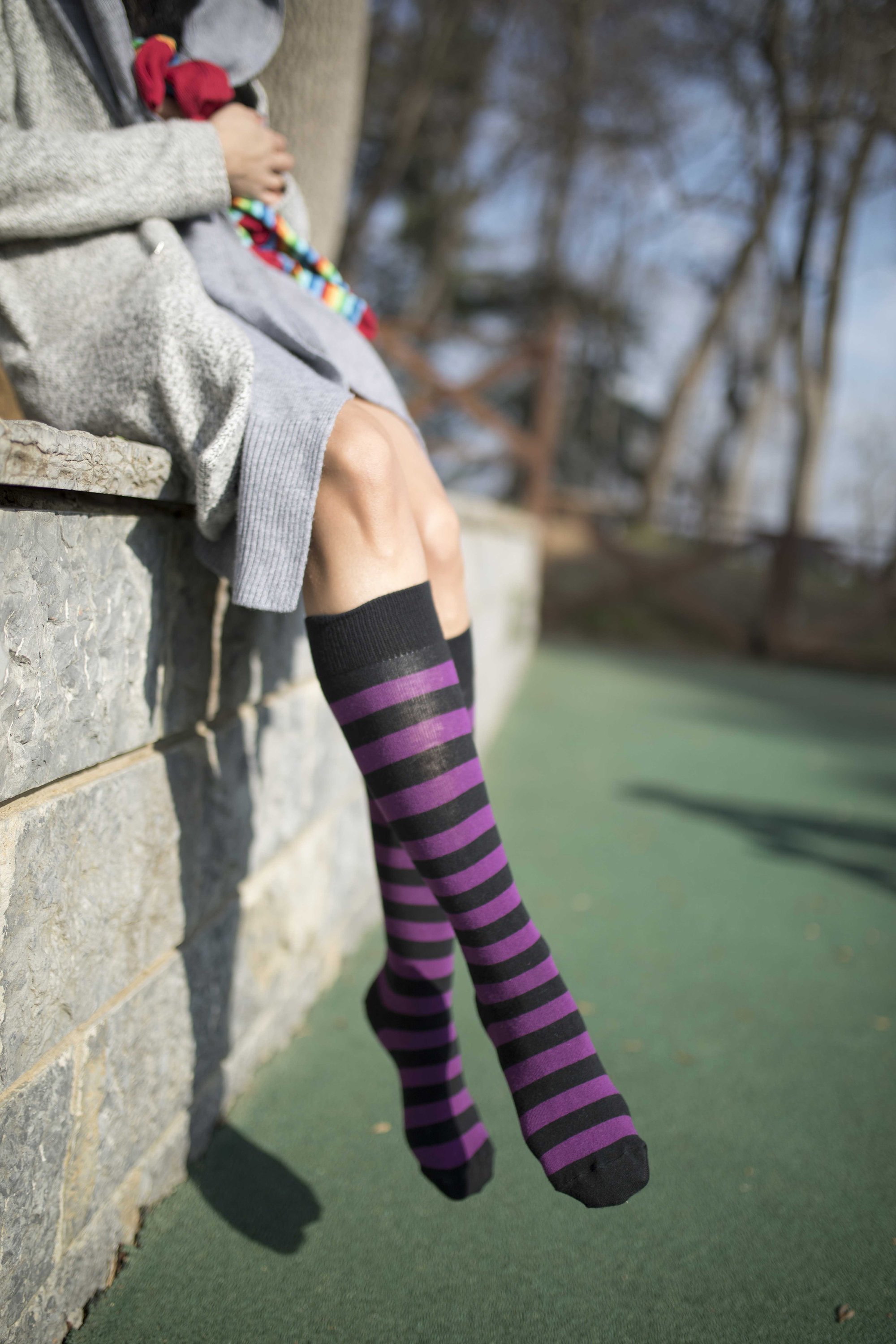 A pair of Women's Plum Stripe Knee High Socks featuring vibrant plum stripes and a comfortable fit, perfect for stylish outfits.