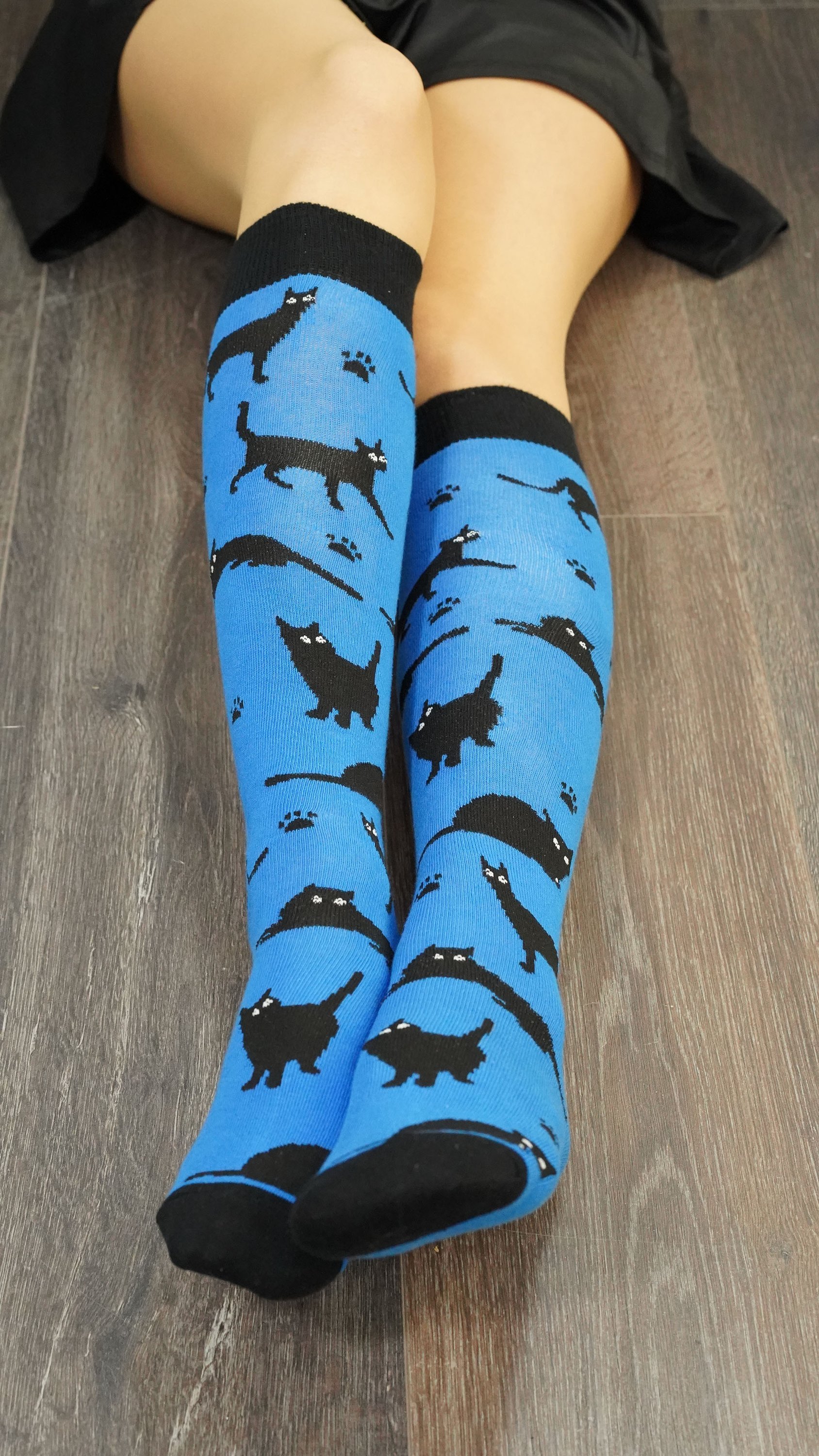 A pair of Women's Shadow Cat Knee High Socks featuring colorful and trendy cat designs, perfect for adding style and comfort to any outfit.