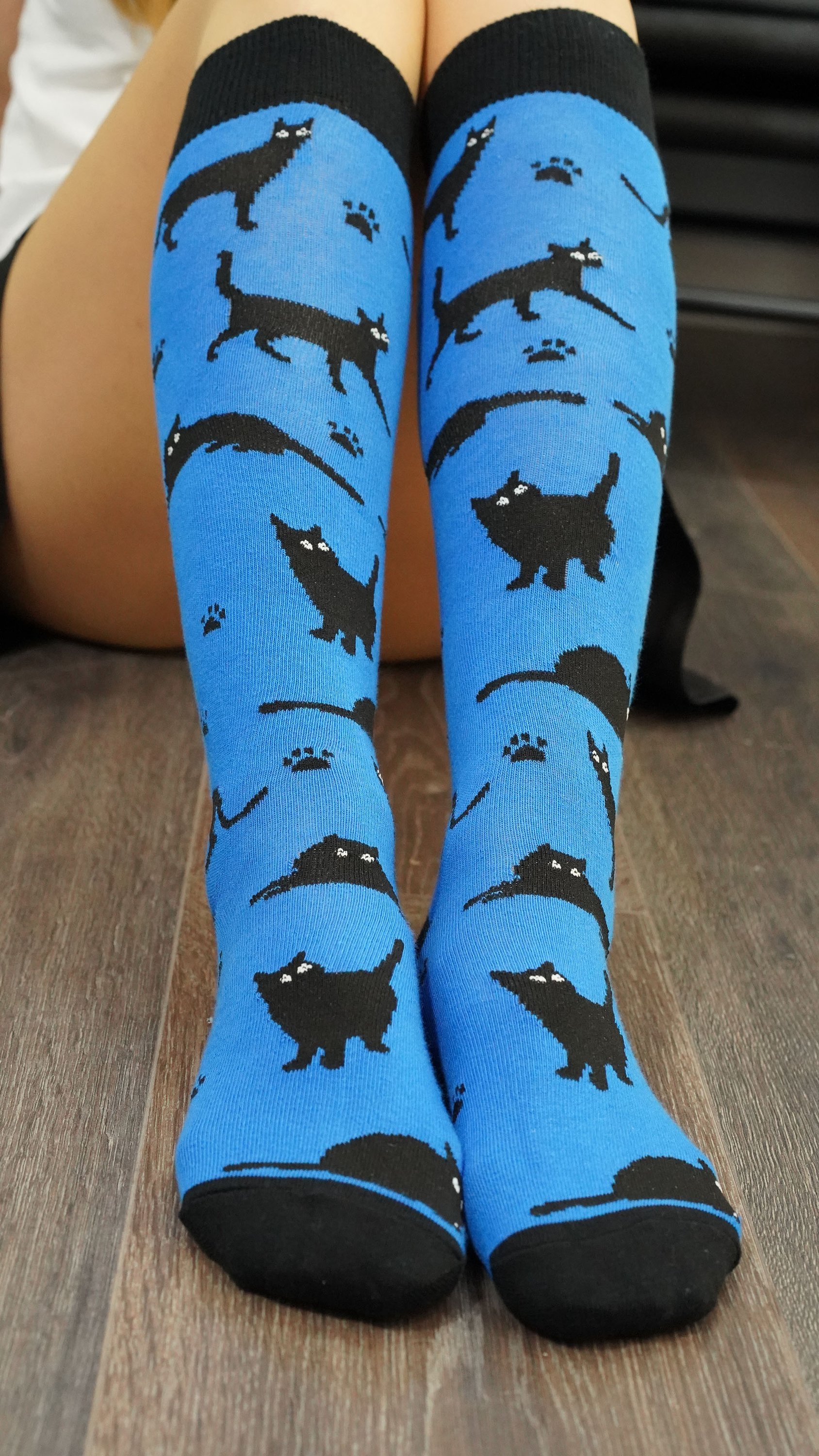 A pair of Women's Shadow Cat Knee High Socks featuring colorful and trendy cat designs, perfect for adding style and comfort to any outfit.