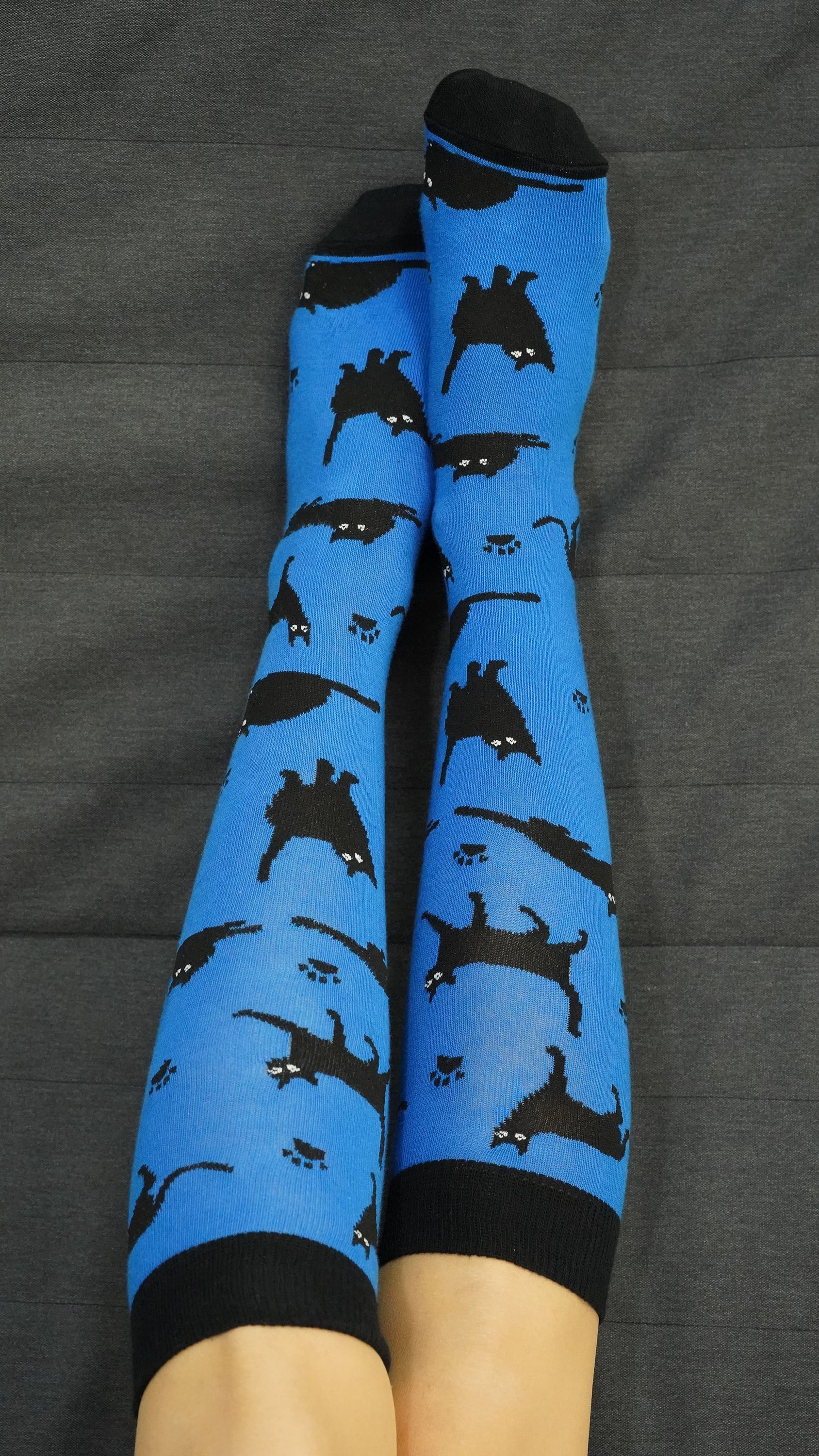 A pair of Women's Shadow Cat Knee High Socks featuring colorful and trendy cat designs, perfect for adding style and comfort to any outfit.