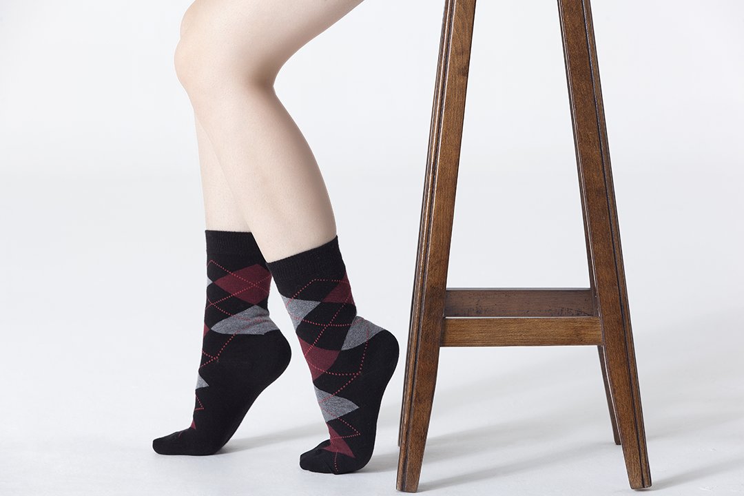 A pair of Women's Shiny Black Argyle Socks featuring a trendy design with a shiny finish, perfect for adding style to any outfit.