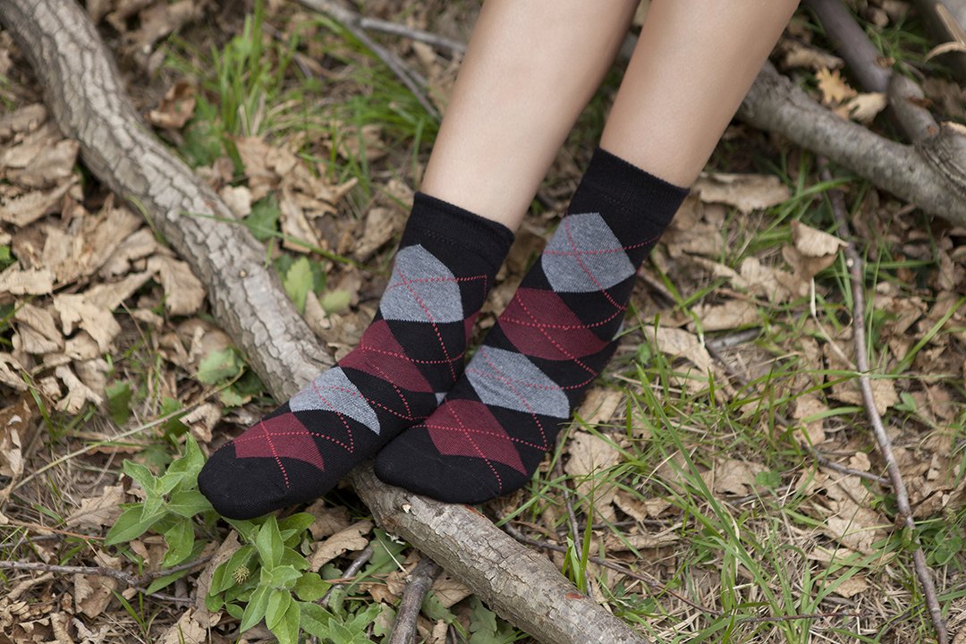 A pair of Women's Shiny Black Argyle Socks featuring a trendy design with a shiny finish, perfect for adding style to any outfit.