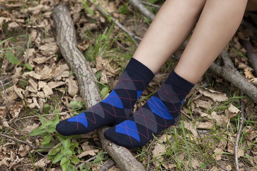 A pair of Women's Shiny Navy Argyle Socks featuring a vibrant argyle pattern, made from soft Turkish cotton for comfort and style.