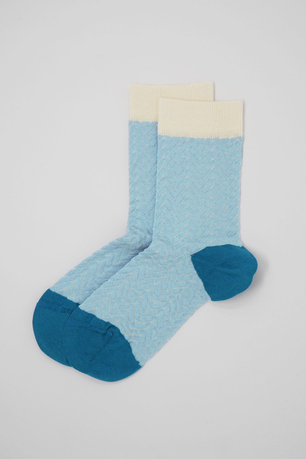 A pair of blue and cream Zigzag women's socks made from luxurious Supima cotton, showcasing a stylish zigzag pattern.