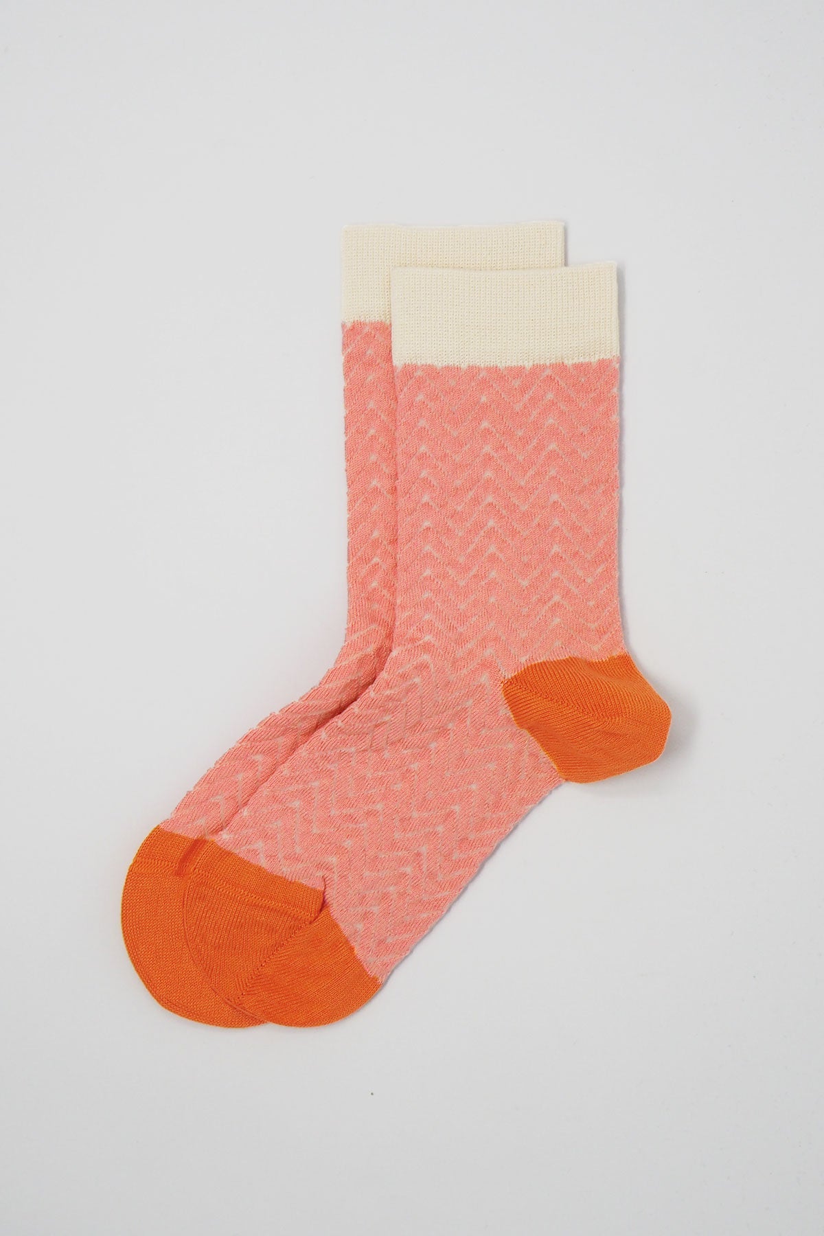 A pair of pink and cream Zigzag women's socks made from luxurious Supima cotton, showcasing a stylish zigzag pattern.