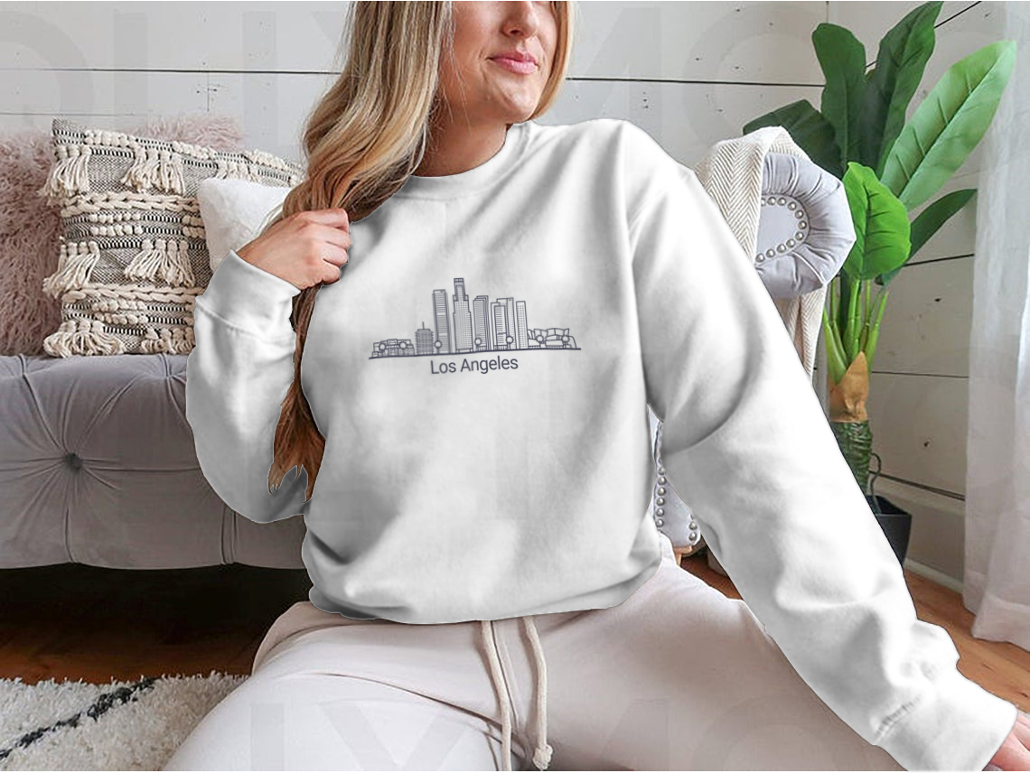 Stylish Banner of Los Angeles City graphic tee in flat line design, showcasing iconic cityscape.