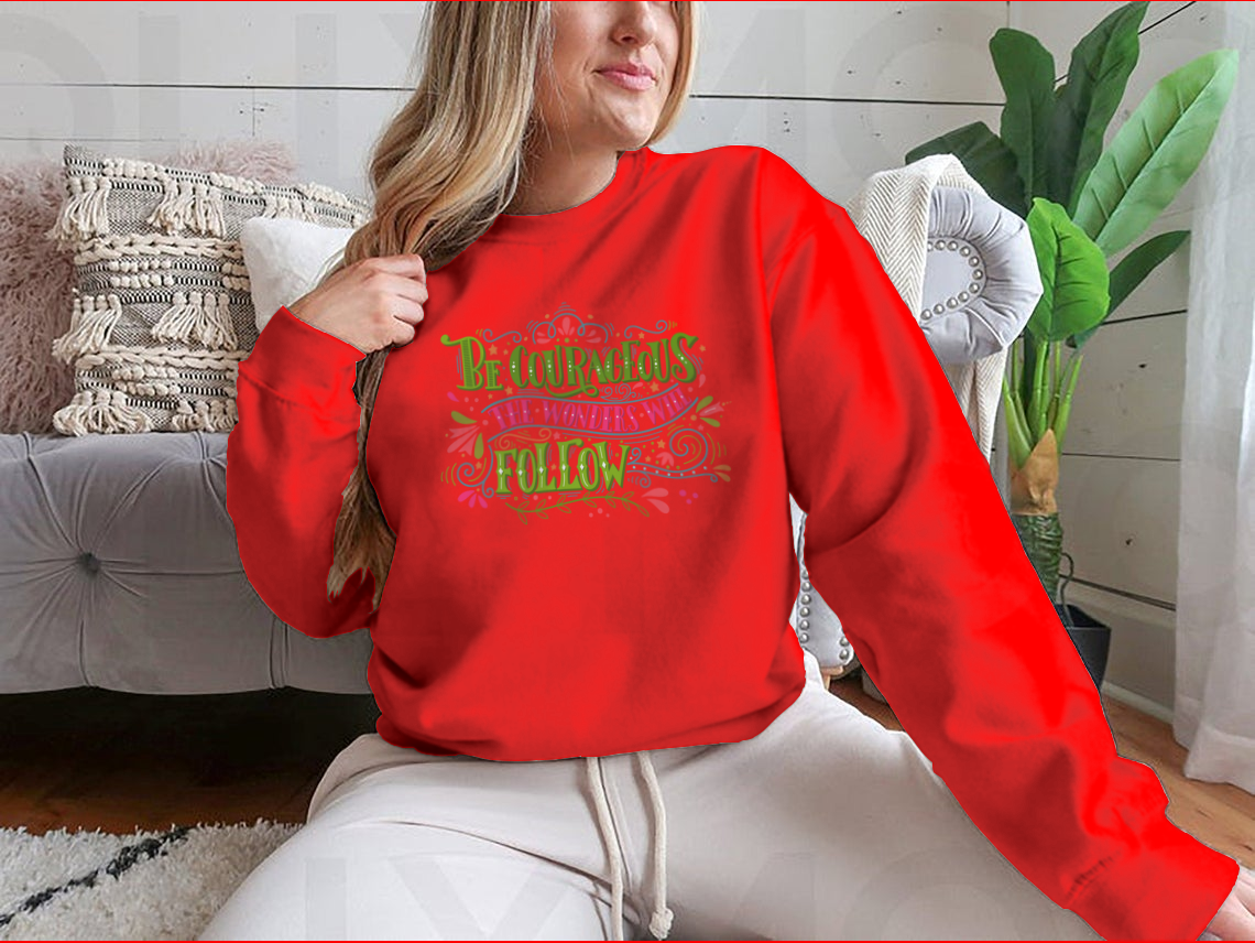 A motivational apparel piece featuring the phrase 'Be Courageous, The Wonders Will Follow' in a stylish design, made from a soft cotton/polyester blend.