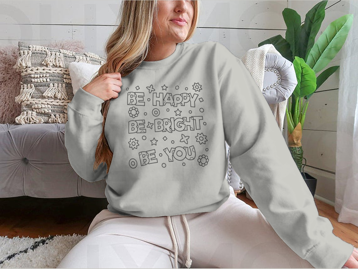 A cozy sweatshirt featuring an inspirational 'Be Happy Be Bright' design, perfect for casual wear.