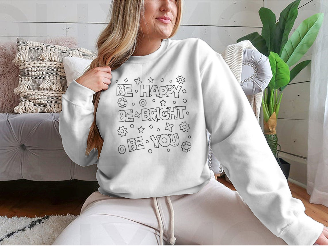 A cozy sweatshirt featuring an inspirational 'Be Happy Be Bright' design, perfect for casual wear.