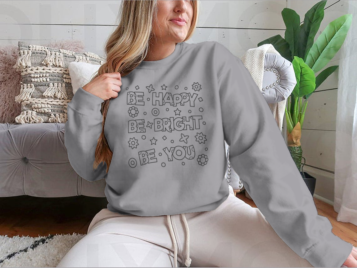 A cozy sweatshirt featuring an inspirational 'Be Happy Be Bright' design, perfect for casual wear.