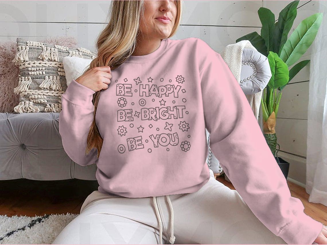 A cozy sweatshirt featuring an inspirational 'Be Happy Be Bright' design, perfect for casual wear.