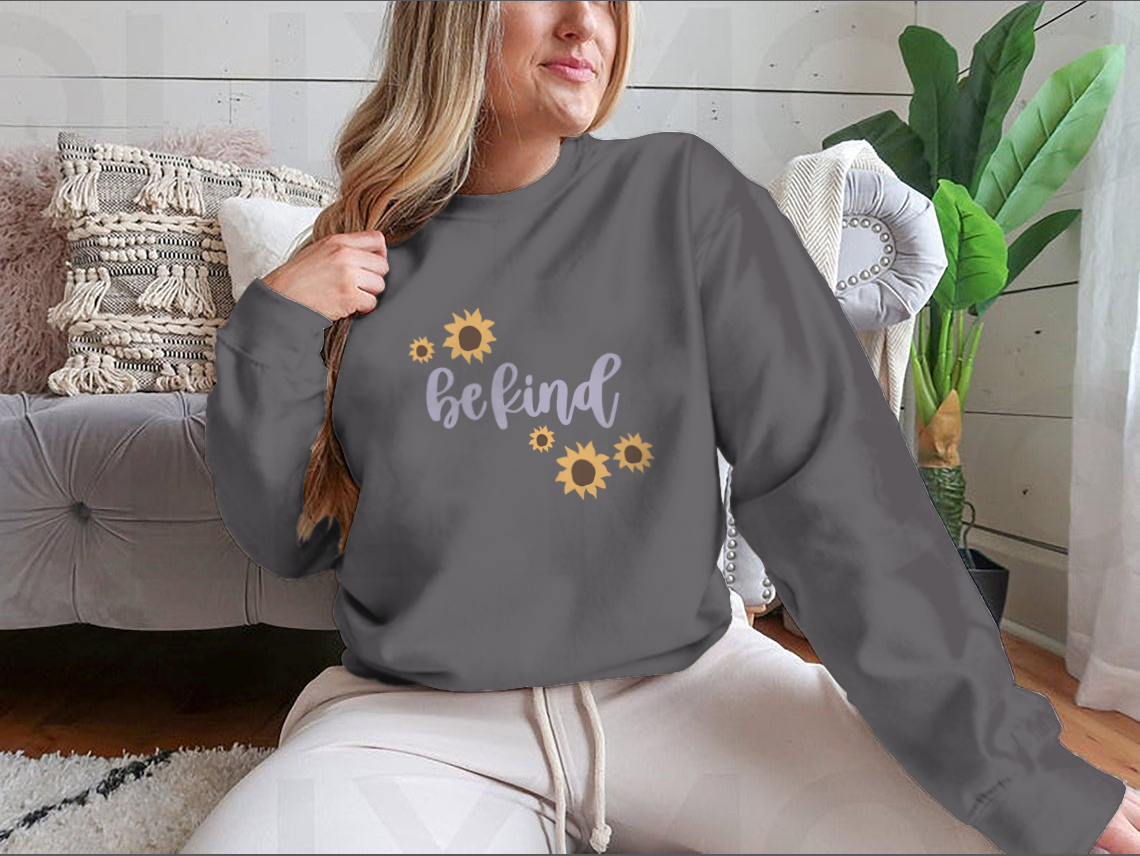 A cozy sweatshirt featuring a cute 'Be Kind' design, made from a soft cotton-polyester blend, perfect for casual wear.