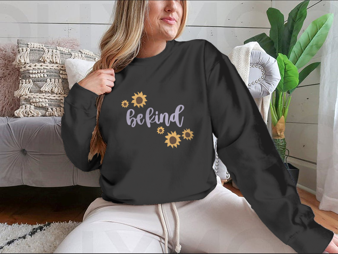 A cozy sweatshirt featuring a cute 'Be Kind' design, made from a soft cotton-polyester blend, perfect for casual wear.