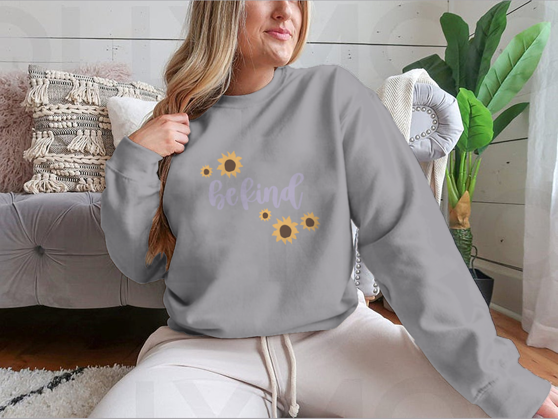 A cozy sweatshirt featuring a cute 'Be Kind' design, made from a soft cotton-polyester blend, perfect for casual wear.