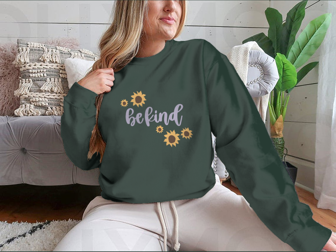 A cozy sweatshirt featuring a cute 'Be Kind' design, made from a soft cotton-polyester blend, perfect for casual wear.