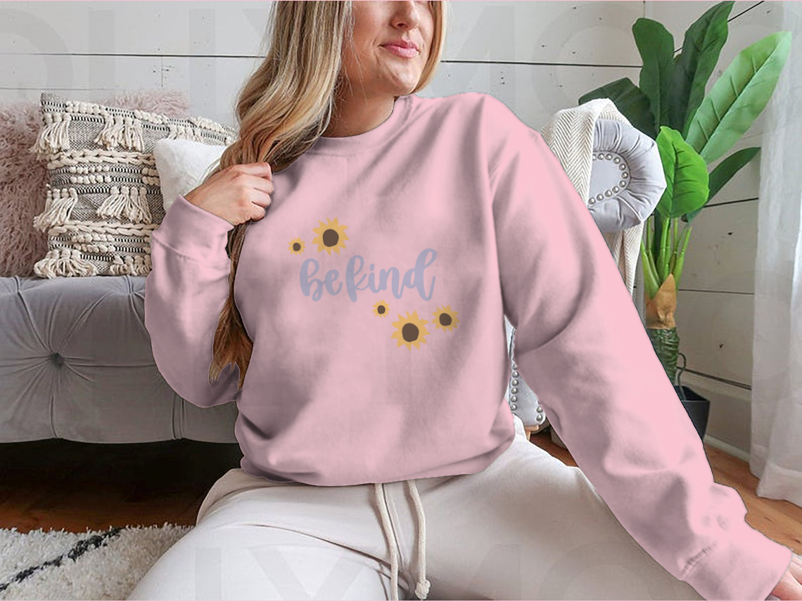 A cozy sweatshirt featuring a cute 'Be Kind' design, made from a soft cotton-polyester blend, perfect for casual wear.