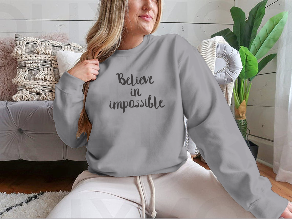 A stylish t-shirt featuring the motivational quote 'Believe In Impossible' designed for inspiration and positivity.