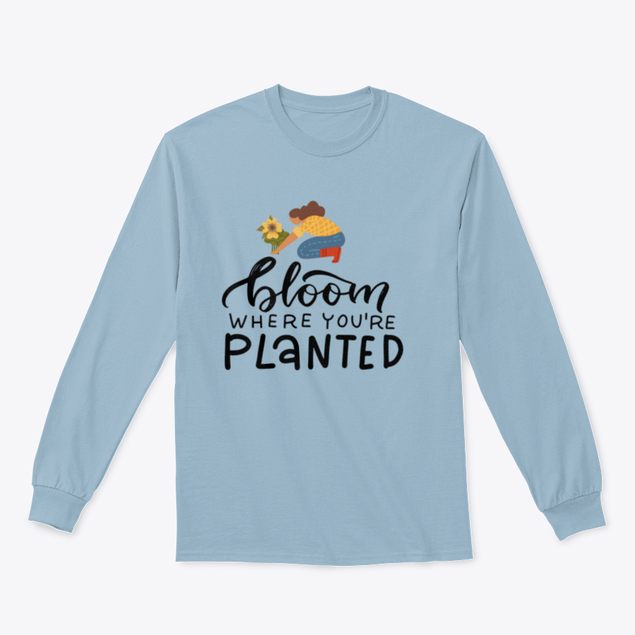 A stylish t-shirt featuring the hand-drawn quote 'Bloom Where You Are Planted' in elegant lettering.