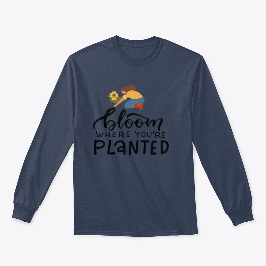 A stylish t-shirt featuring the hand-drawn quote 'Bloom Where You Are Planted' in elegant lettering.