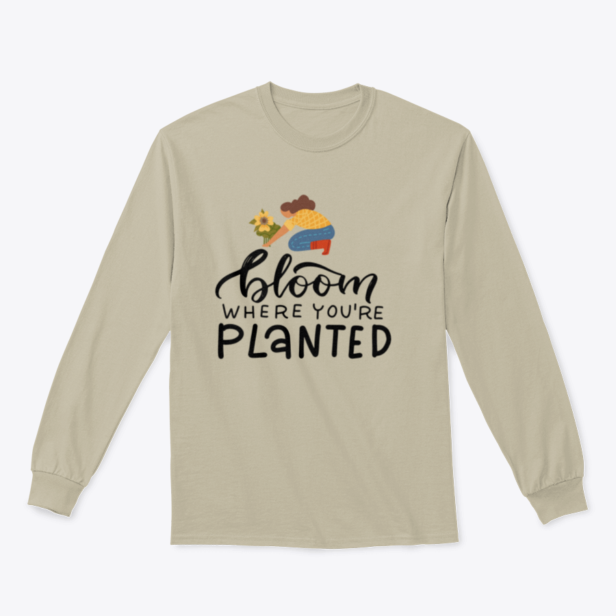 A stylish t-shirt featuring the hand-drawn quote 'Bloom Where You Are Planted' in elegant lettering.