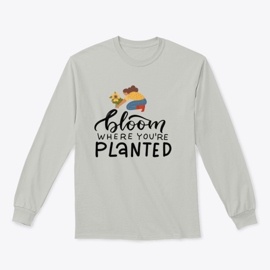 A stylish t-shirt featuring the hand-drawn quote 'Bloom Where You Are Planted' in elegant lettering.