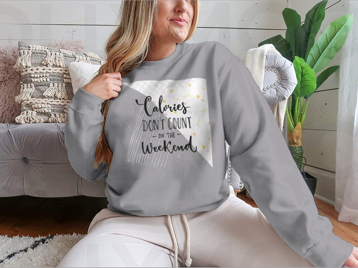 A cozy sweatshirt featuring the phrase 'Calories Don't Count On The Weekend' in a fun design, made from a cotton/polyester blend.