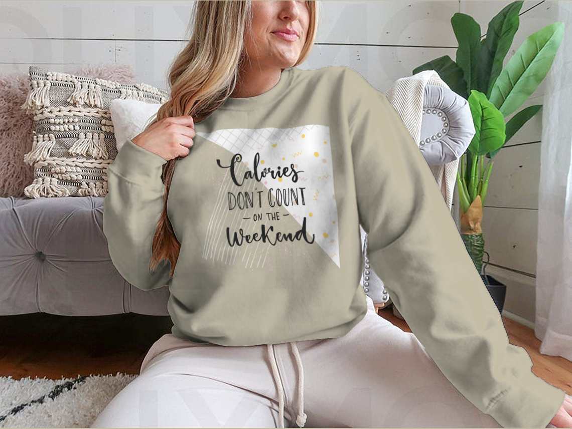 A cozy sweatshirt featuring the phrase 'Calories Don't Count On The Weekend' in a fun design, made from a cotton/polyester blend.