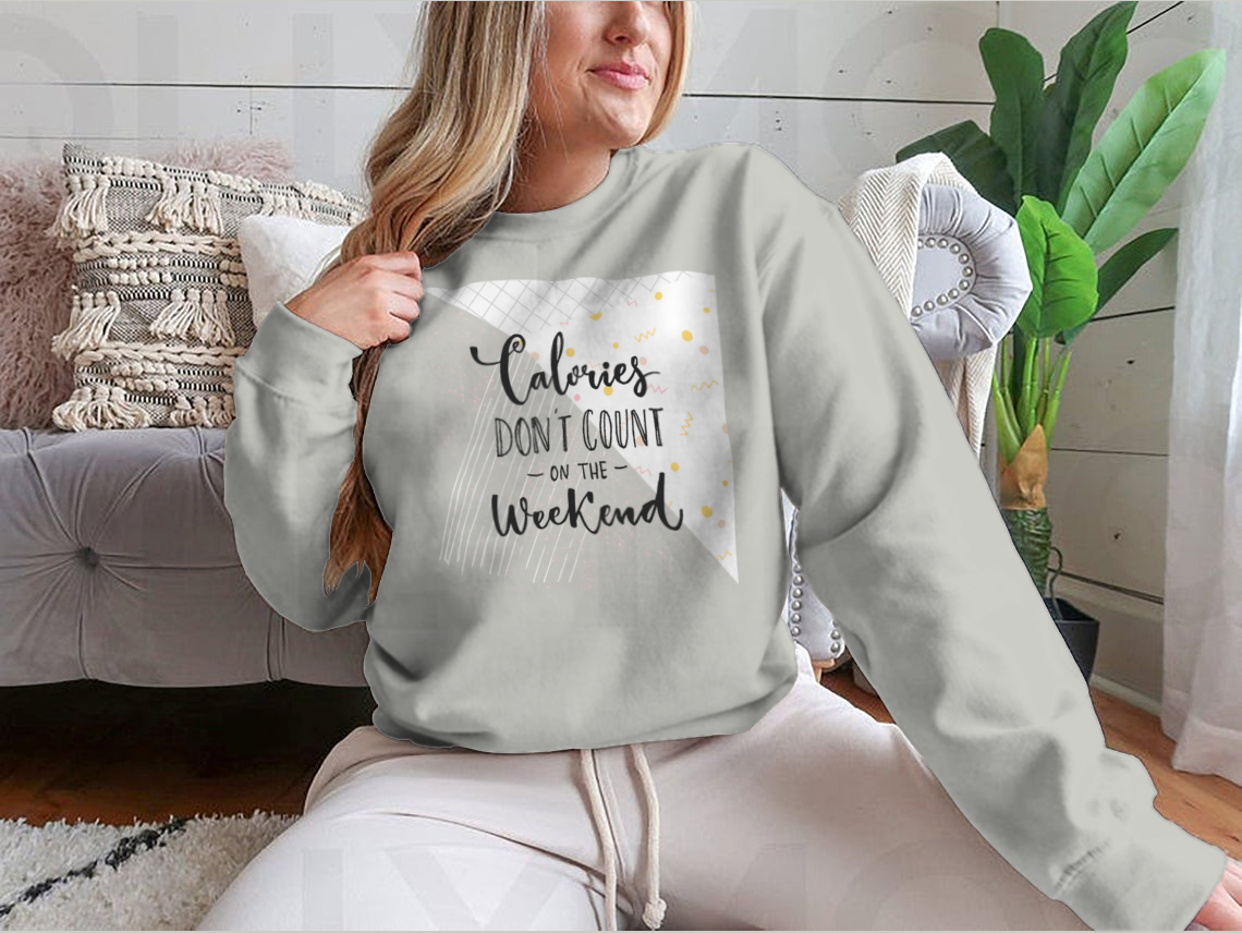 A cozy sweatshirt featuring the phrase 'Calories Don't Count On The Weekend' in a fun design, made from a cotton/polyester blend.