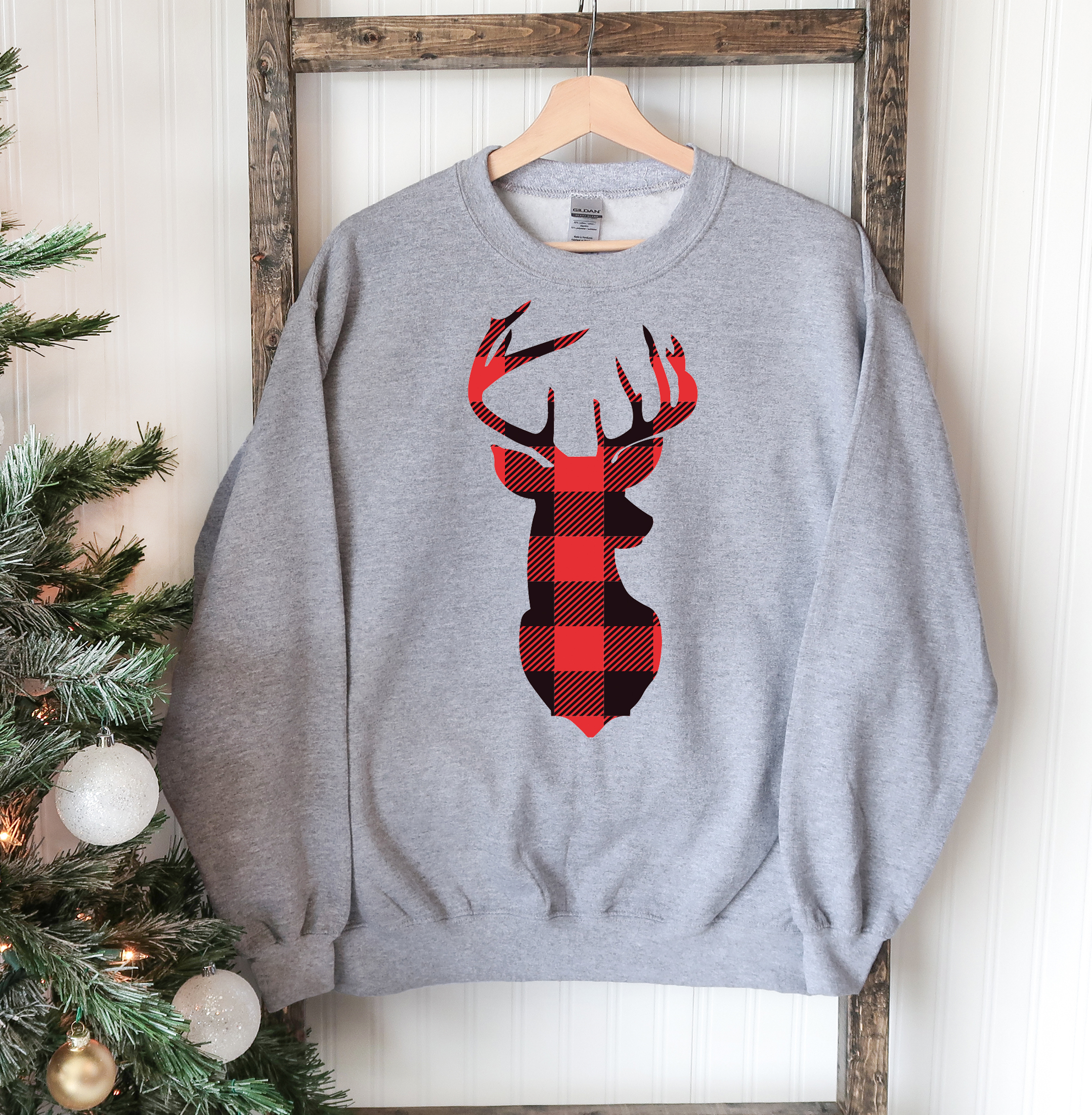 A cozy Christmas Deer Sweatshirt featuring a festive deer design, perfect for holiday celebrations and casual wear.