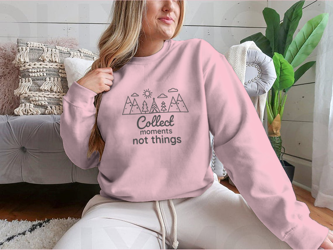 A cozy sweatshirt featuring the inspirational phrase 'Collect Moments Not Things' in a stylish design, perfect for casual wear.