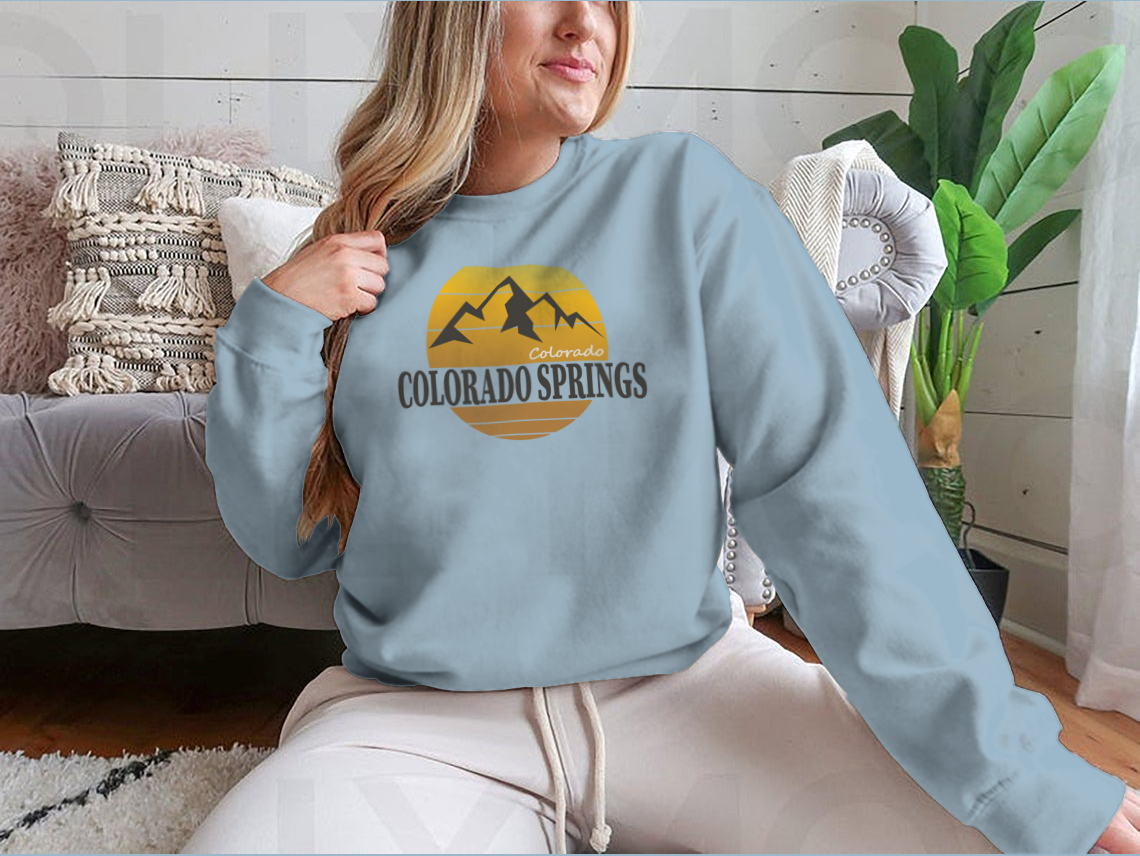 A cozy Colorado Springs Colorado Tourism sweatshirt in various colors, showcasing its classic fit and soft fabric.