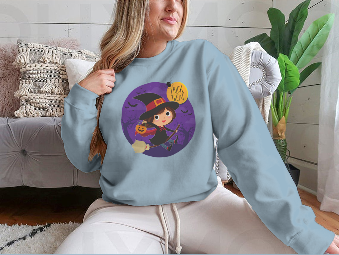 A cute cartoon illustration of a witch flying on a broomstick, featured on a comfortable cotton shirt design.