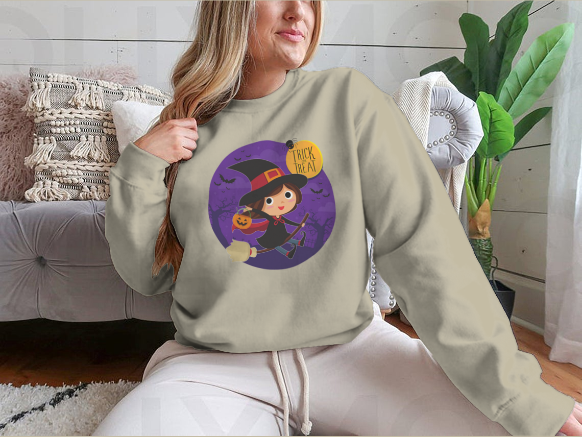 A cute cartoon illustration of a witch flying on a broomstick, featured on a comfortable cotton shirt design.