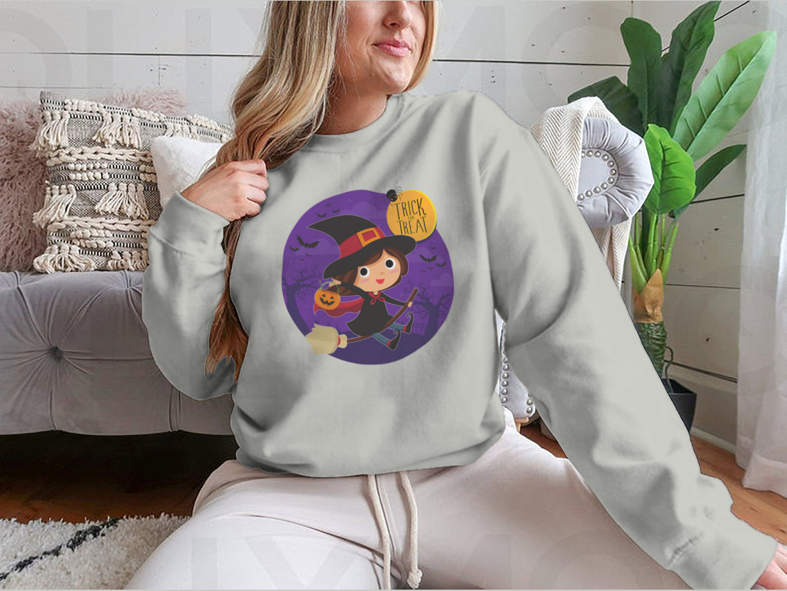 A cute cartoon illustration of a witch flying on a broomstick, featured on a comfortable cotton shirt design.