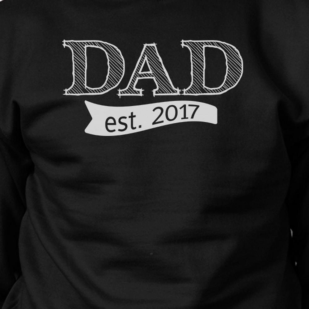 A black unisex sweatshirt featuring a unique graphic that reads 'Dad Est 2017', made from a comfortable cotton-polyester blend, perfect for Father's Day gifts.