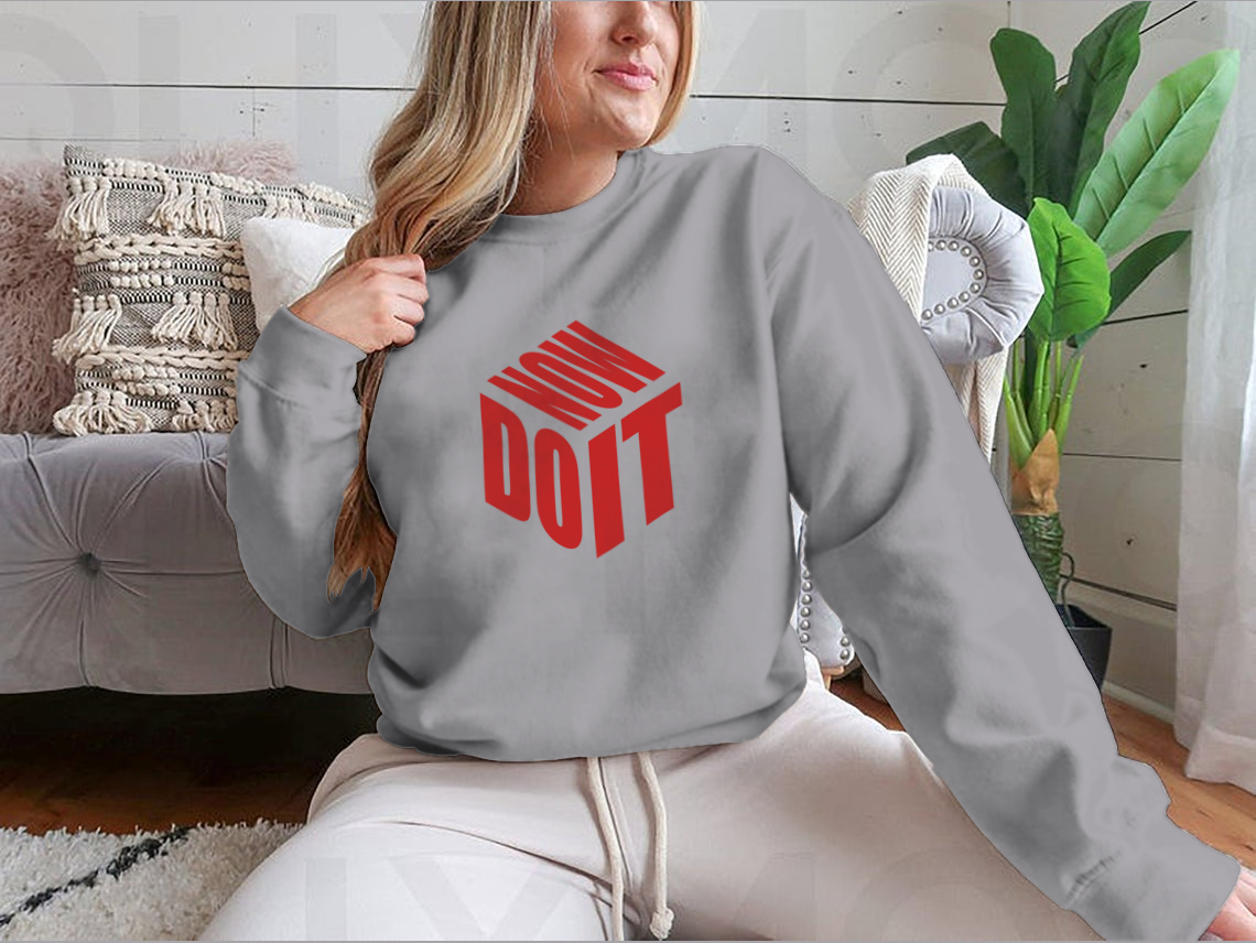 A motivational sweatshirt featuring the phrase 'Do It Now' in a simple design, made from a comfortable cotton/polyester blend.