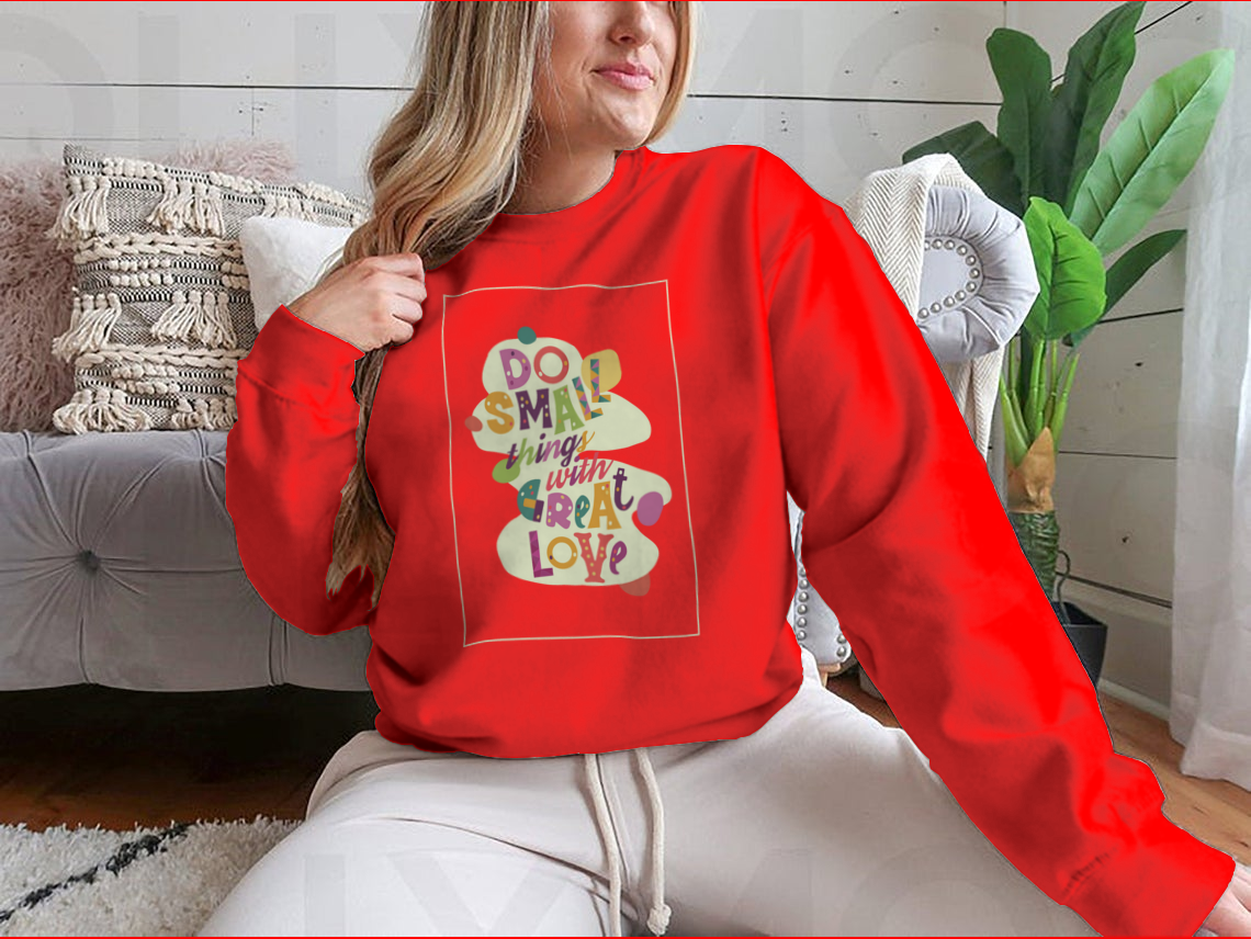 A cozy sweatshirt featuring the inspirational quote 'Do Small Things With Great Love', showcasing a classic fit and soft fabric.