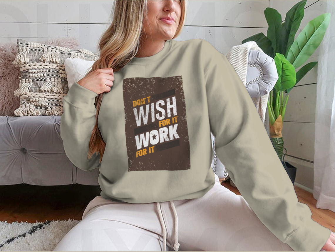 A stylish sweatshirt featuring the motivational quote 'Don't Wish For It, Work For It' in bold lettering, made from a soft cotton-polyester blend.