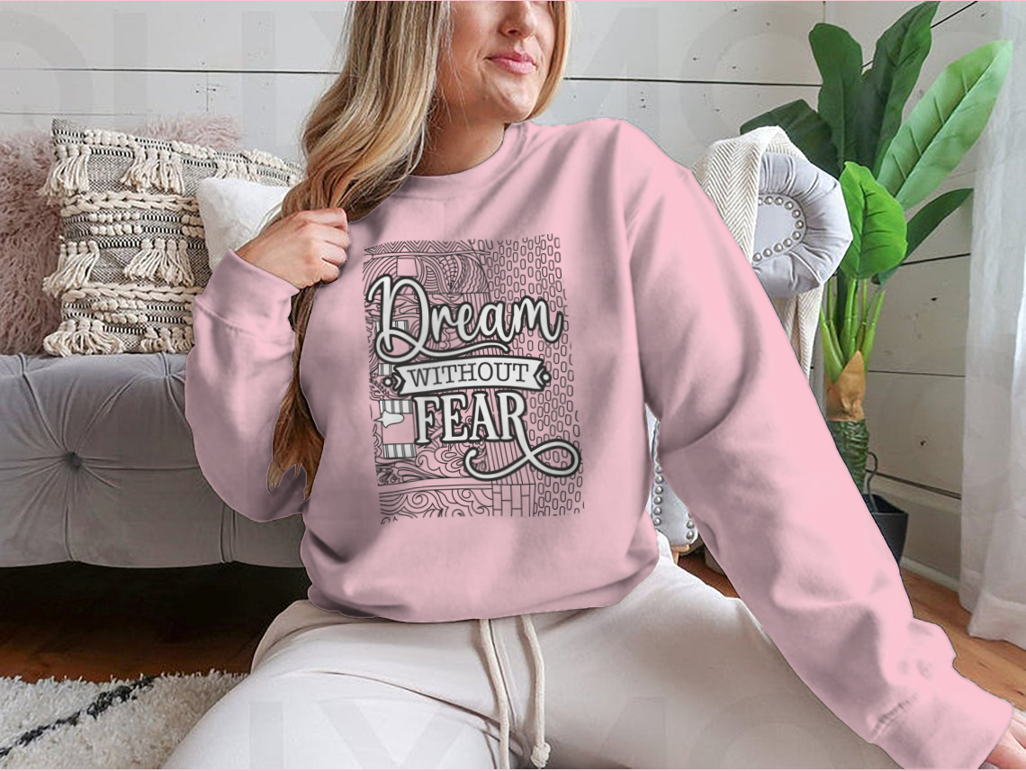 A cozy sweatshirt featuring the inspirational phrase 'Dream With Out Fear' in stylish typography, perfect for casual wear.