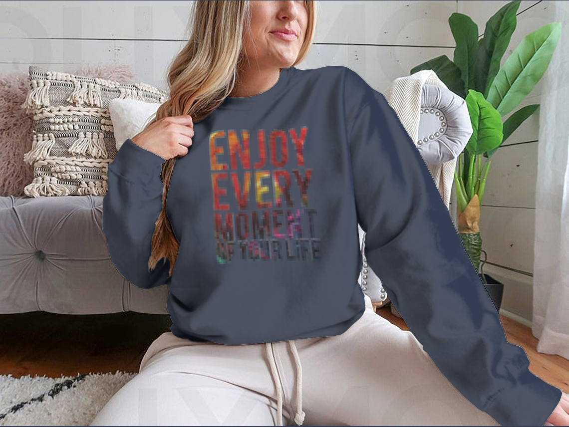 A motivational t-shirt featuring the phrase 'Enjoy Every Moment Of Your Life', made from a comfortable cotton/polyester blend.