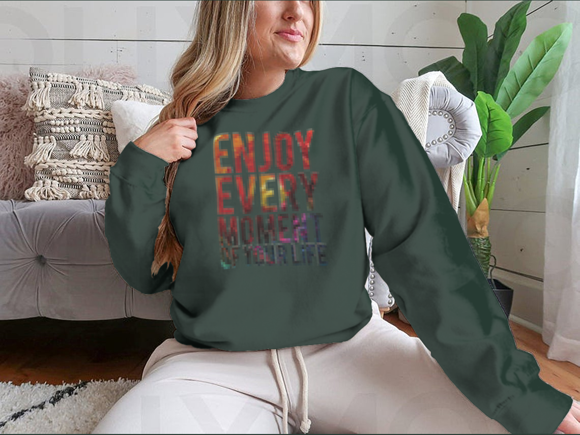 A motivational t-shirt featuring the phrase 'Enjoy Every Moment Of Your Life', made from a comfortable cotton/polyester blend.