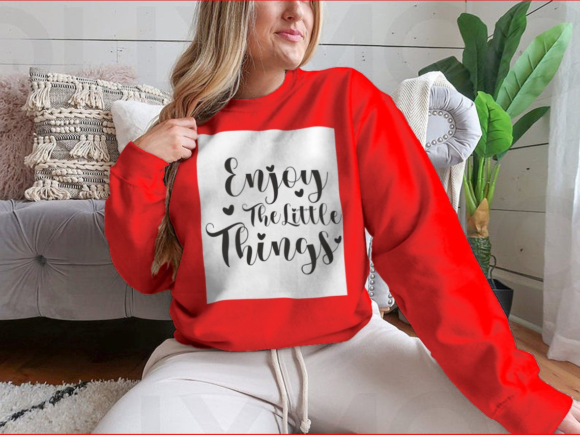 A cozy sweatshirt featuring the calligraphy design 'Enjoy The Little Things', showcasing its soft fabric and classic fit.