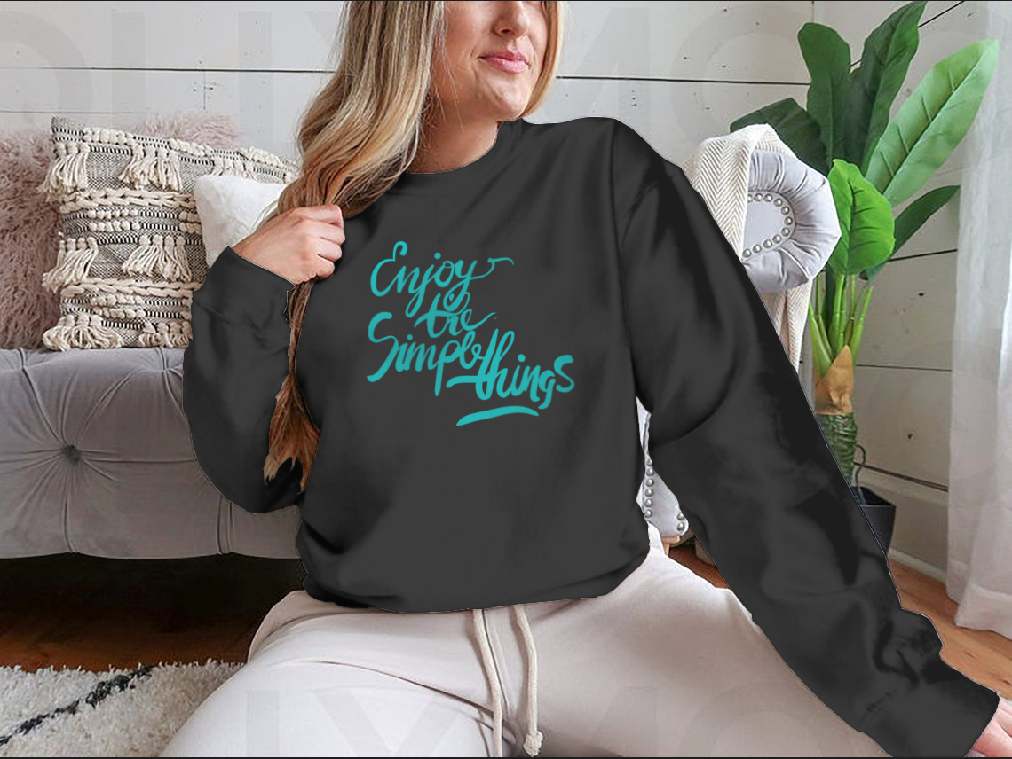 A stylish T-shirt featuring the motivational quote 'Enjoy The Simple Things' in modern calligraphy, showcasing its comfortable fabric and classic fit.