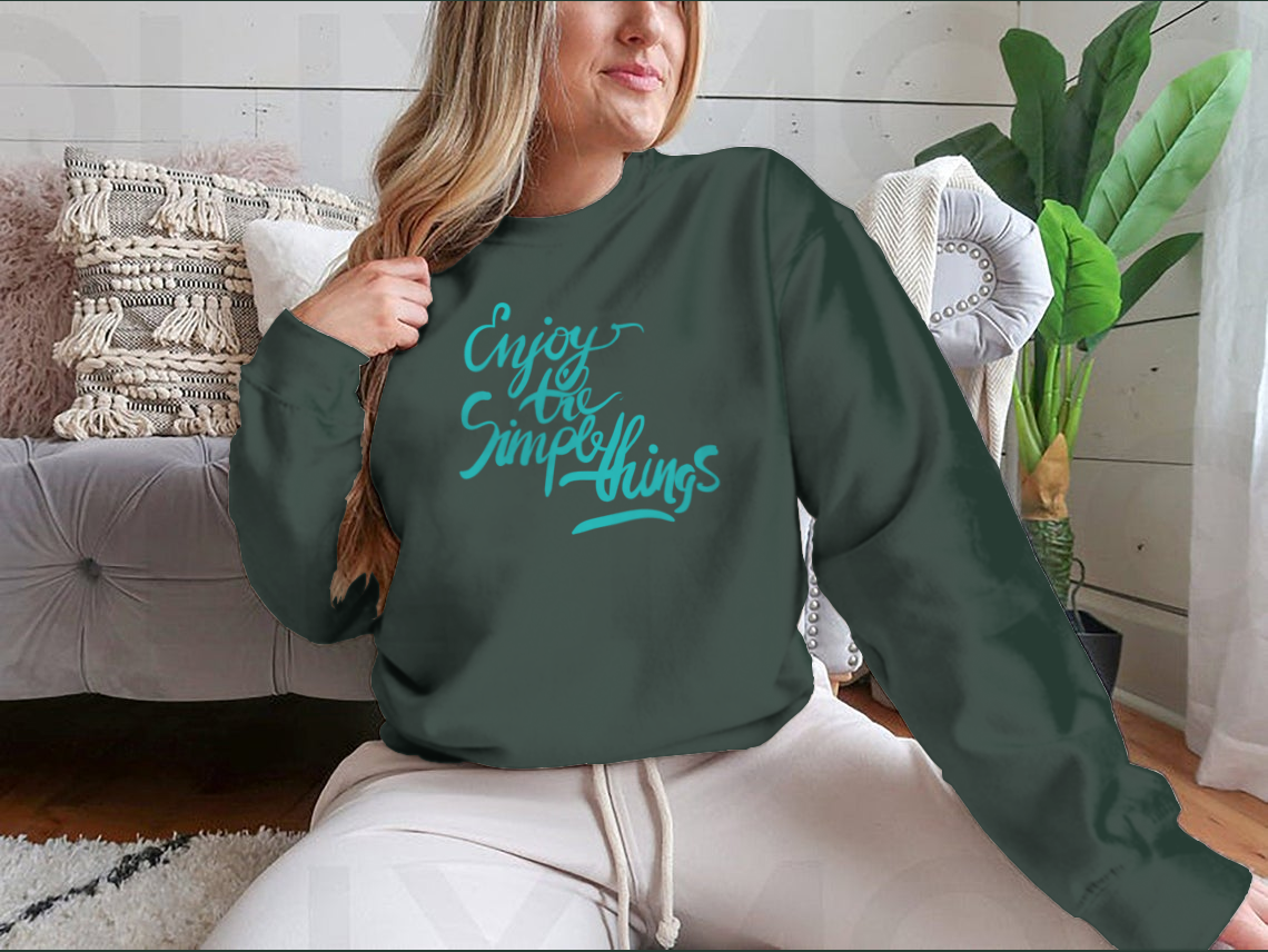 A stylish T-shirt featuring the motivational quote 'Enjoy The Simple Things' in modern calligraphy, showcasing its comfortable fabric and classic fit.