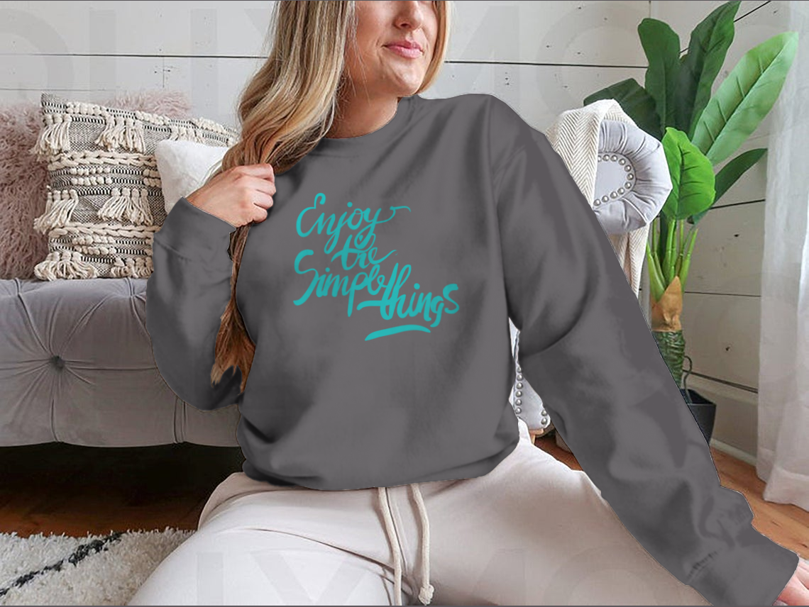 A stylish T-shirt featuring the motivational quote 'Enjoy The Simple Things' in modern calligraphy, showcasing its comfortable fabric and classic fit.