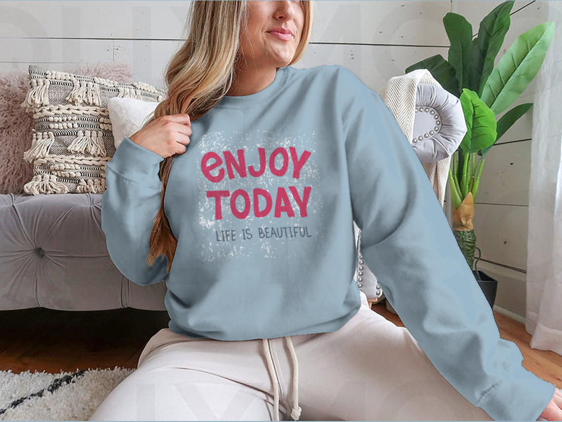 A comfortable t-shirt featuring hand-drawn typography that reads 'Enjoy Today', showcasing a stylish and inspirational design.